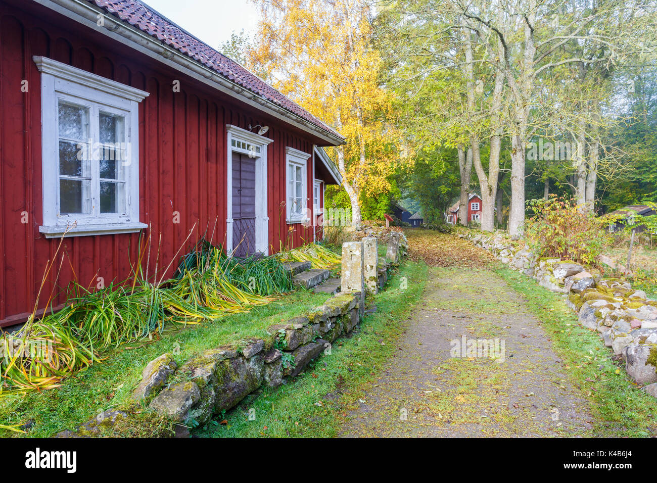 Old red cottage in the countryside by a road Stock Photo Alamy