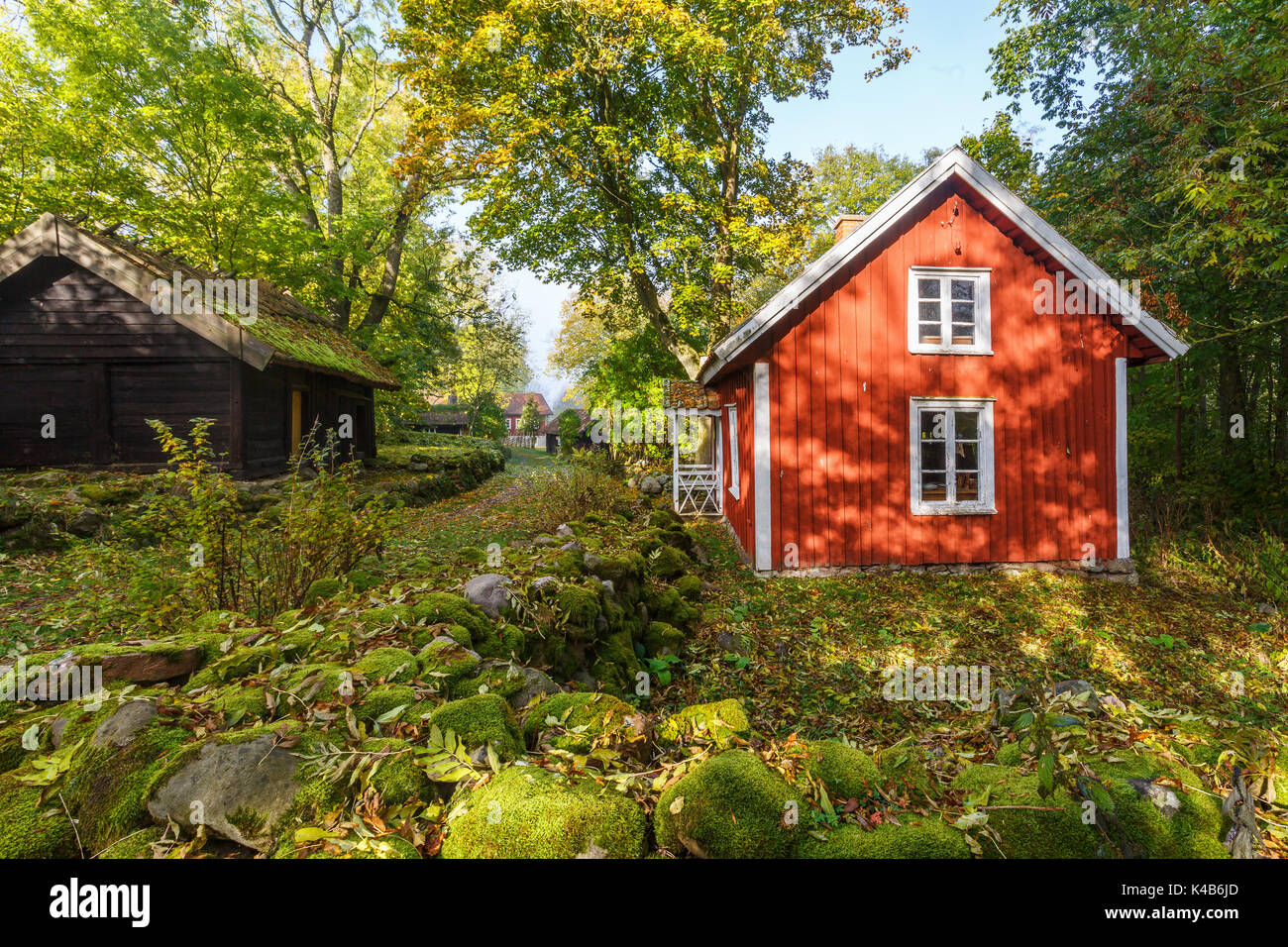 Idyllic old red cottage in the countryside by a road Stock Photo Alamy