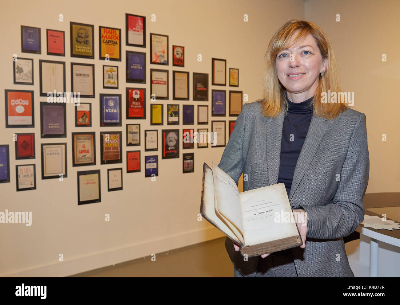 Hamburg, Germany. 5th Sep, 2017. The director Rita Mueller holds an original first edition book of 'Das Kapital' of Karl Marx in the Museum of Work in Hamburg, Germany, 5 September 2017. The special exhibition is held for the 150th jubilee of the publishing of the first band of Marx's 'Capital'. The exhibition can be seen between the 6th of September 2017 and the 4th of March 2018. Photo: Georg Wendt/dpa/Alamy Live News Stock Photo