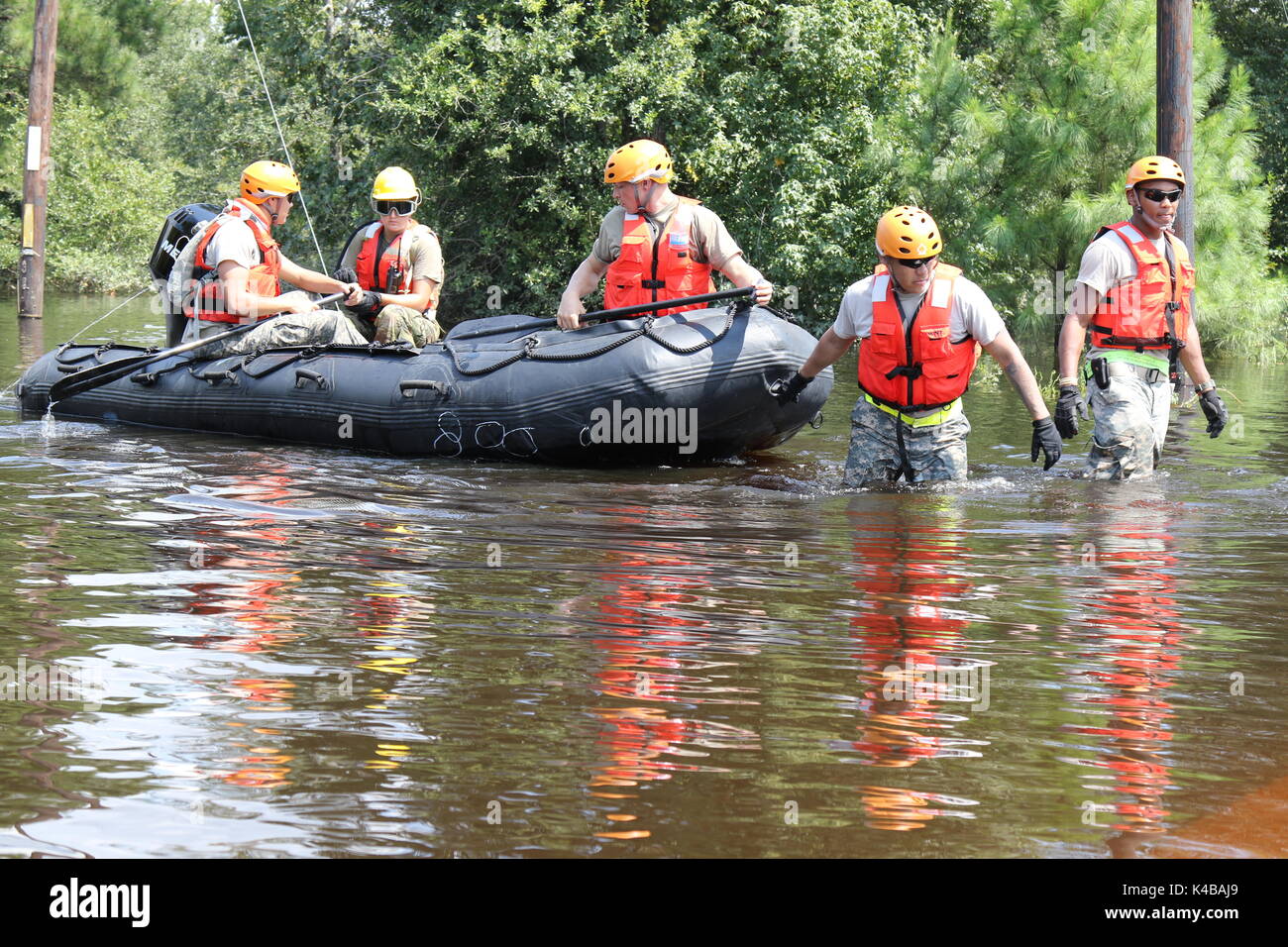 U.S Army soldiers use a rubber boat to search for residents in need of assistance trapped by floodwaters in the aftermath of Hurricane Harvey September 4, 2017 in Port Arthur, Texas. Stock Photo