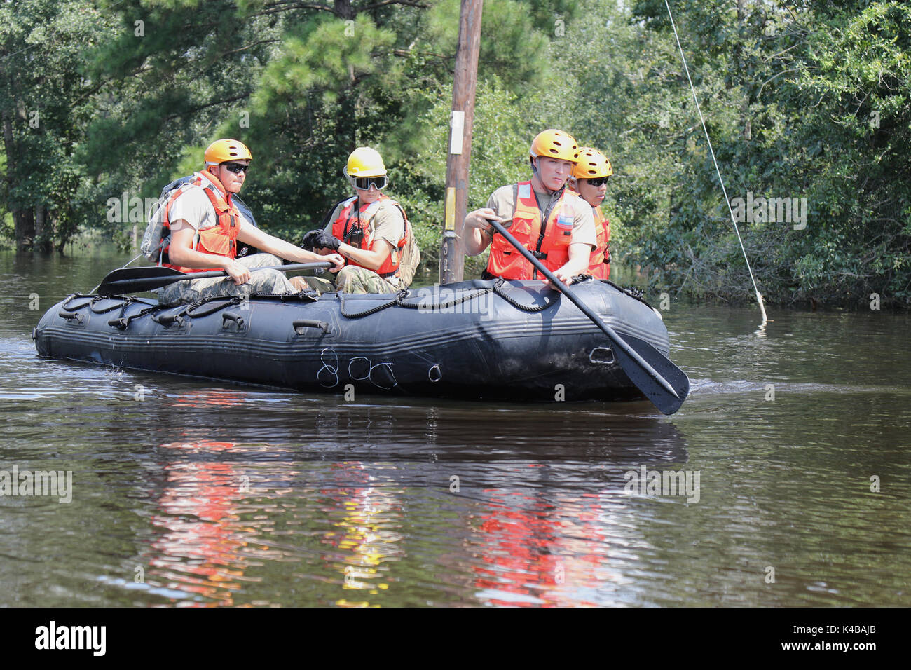U.S Army soldiers use a rubber boat to search for residents in need of assistance trapped by floodwaters in the aftermath of Hurricane Harvey September 4, 2017 in Port Arthur, Texas. Stock Photo
