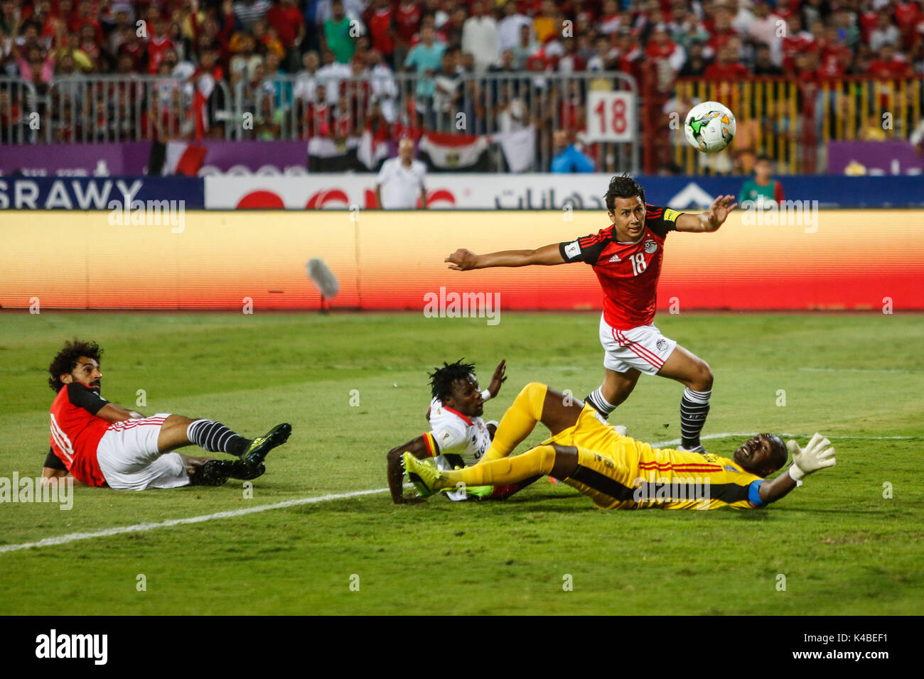 Alexandria, Egypt. 5th Sep, 2017. Egypt's Mohamed Salah, lay down left, scores his side's opening goal against Uganda's goalkeeper Denis Onyango, lay down right, during the 2018 World Cup group E qualifying soccer match between Egypt and Uganda at the Borg El Arab Stadium in Alexandria, Egypt, Tuesday, Sept. 5, 2017. Credit: Islam Safwat/Alamy Live News Stock Photo