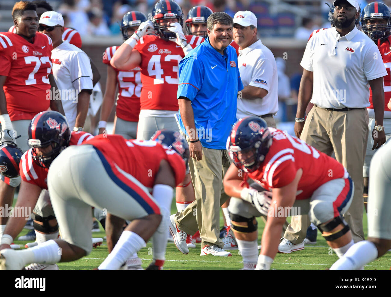 Oxford, MS, USA. 2nd Sep, 2017. Mississippi interim coach Matt Luke (center) smiles as he watches his players go through pre game warm ups before a NCAA college football game against South Alabama at Vaught-Hemmingway Stadium in Oxford, MS. Mississippi won 47-27. Austin McAfee/CSM/Alamy Live News Stock Photo