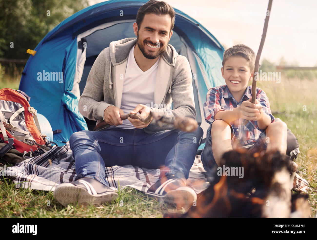 Father and his son spending time together on camping Stock Photo - Alamy