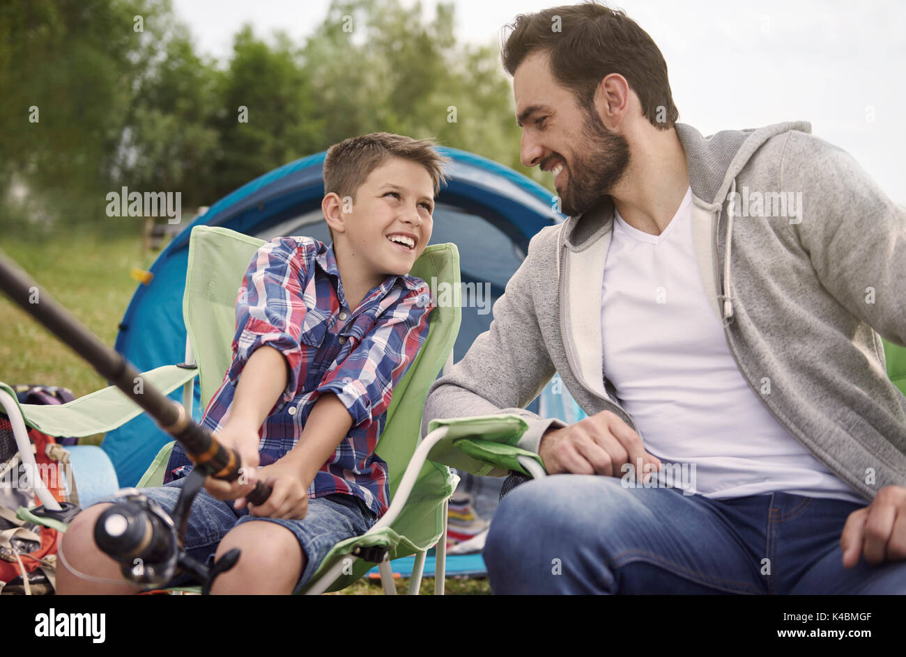 Father teaching his son how to fish Stock Photo - Alamy
