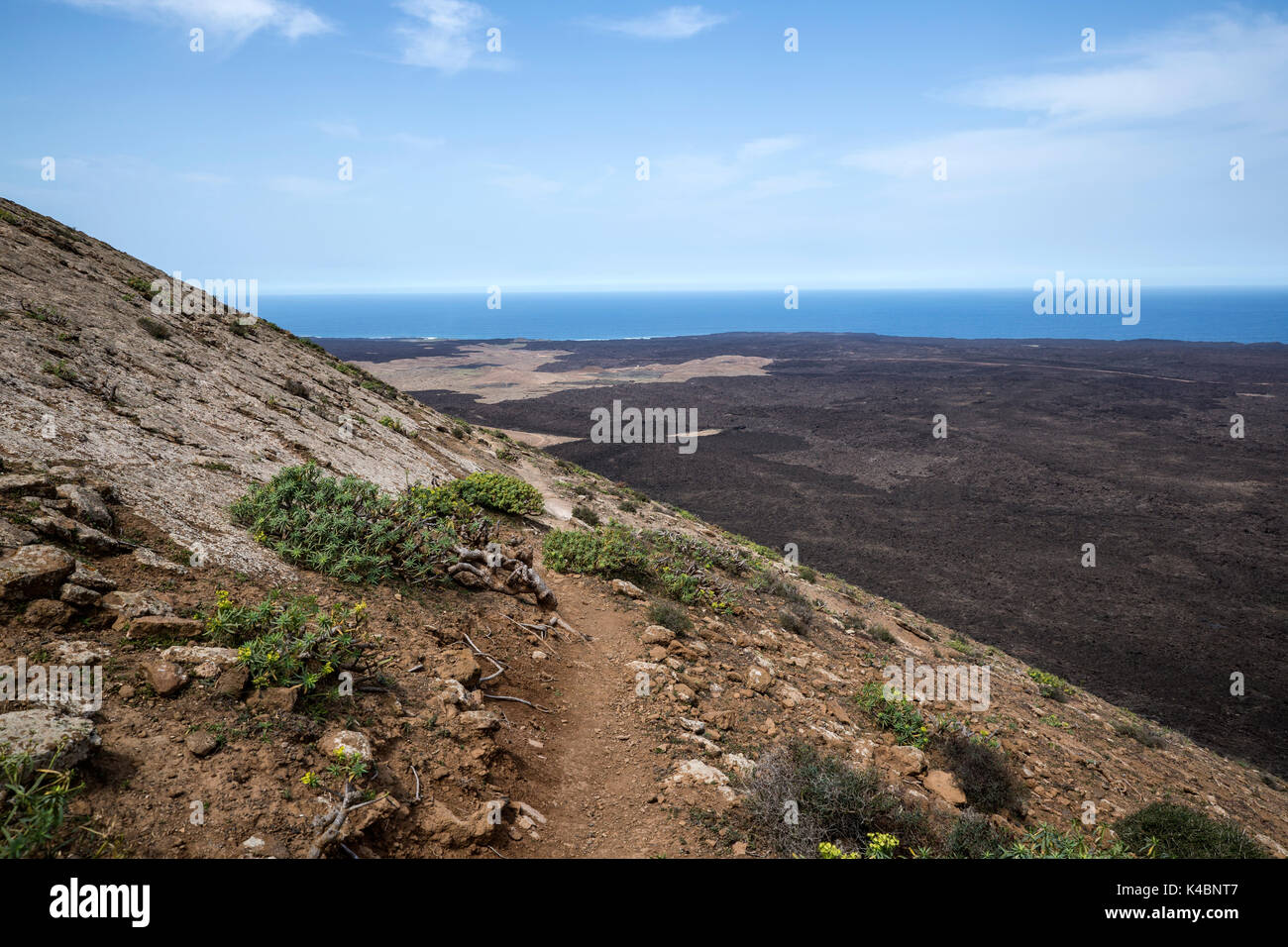 Cold Lava Flow And Volcano Crater West Of Mancha Blanca In Timanfaya National Park, Lanzarote, Canary Islands, Spain Stock Photo