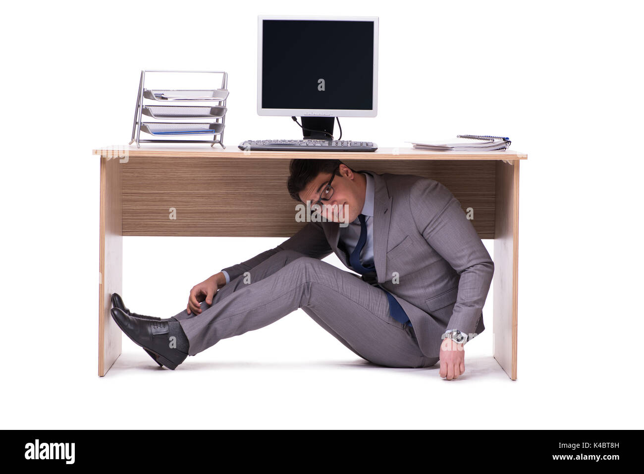 Person hiding under desk hi-res stock photography and images - Alamy