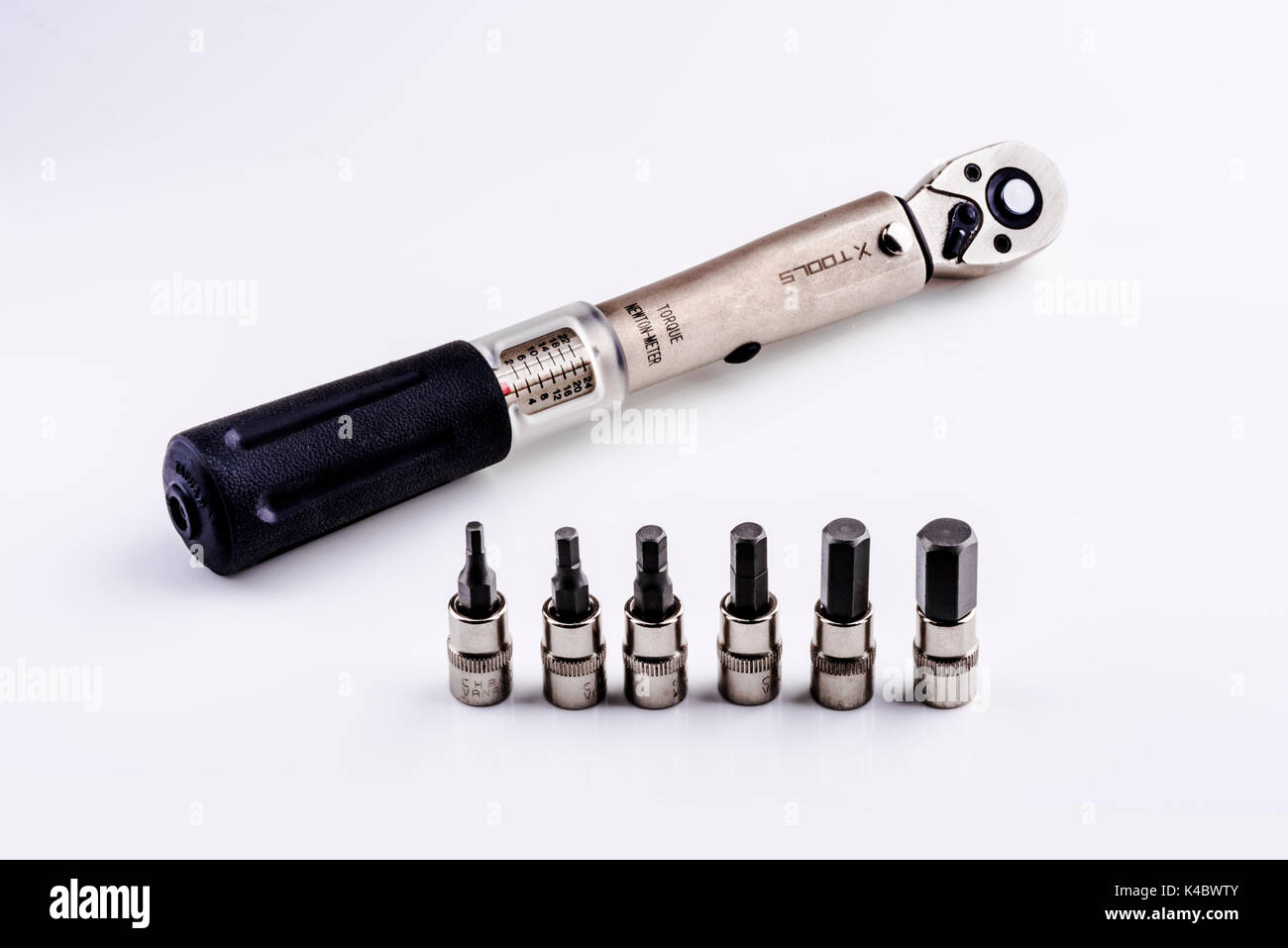 A ratchet preset torque wrench with a set of hex bits Stock Photo Alamy