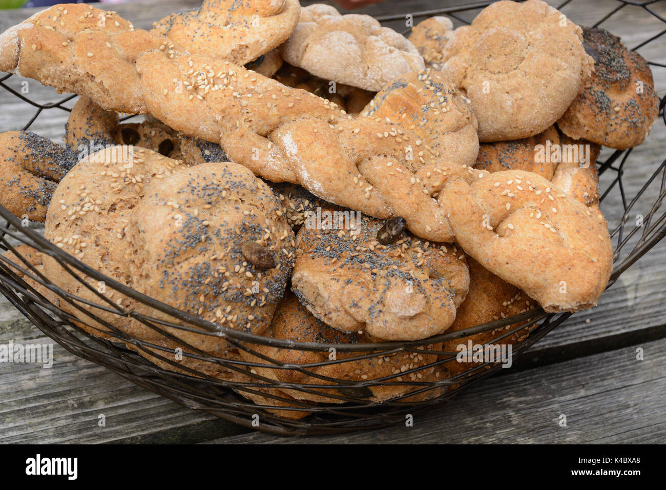 HomeBaked WholeGrain Bread Rolls In Rusical Bread Basket Stock Photo