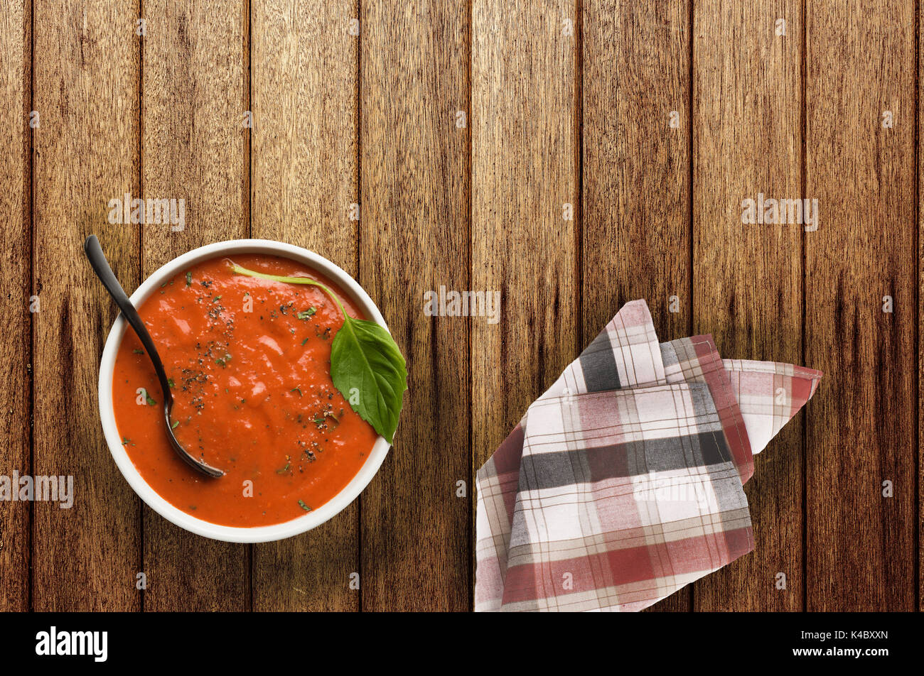 roasted tomato basil soup on wooden table Stock Photo