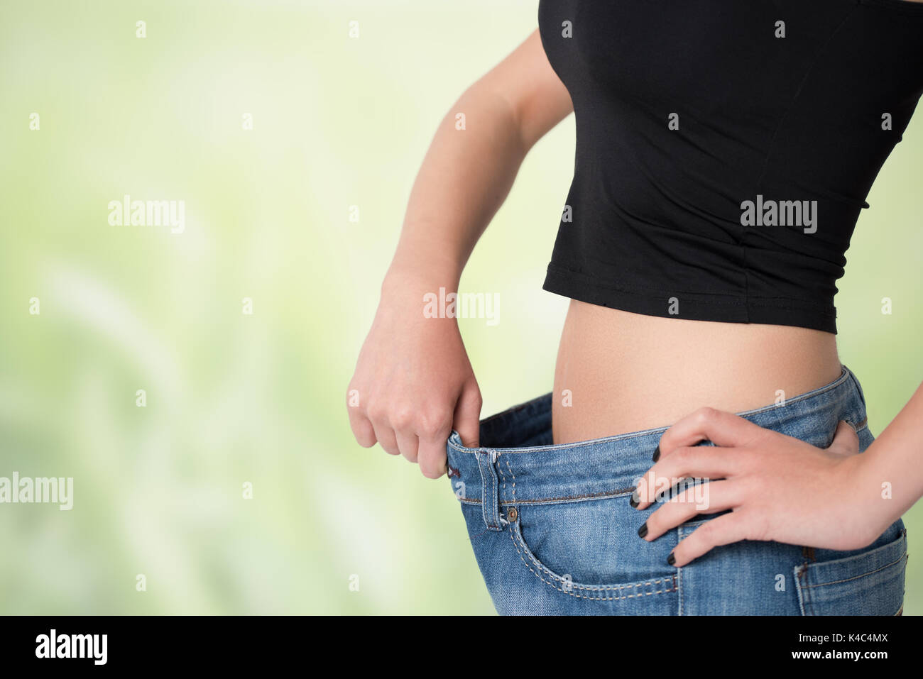 Thin woman in big pants weight loss concepts Stock Photo Alamy