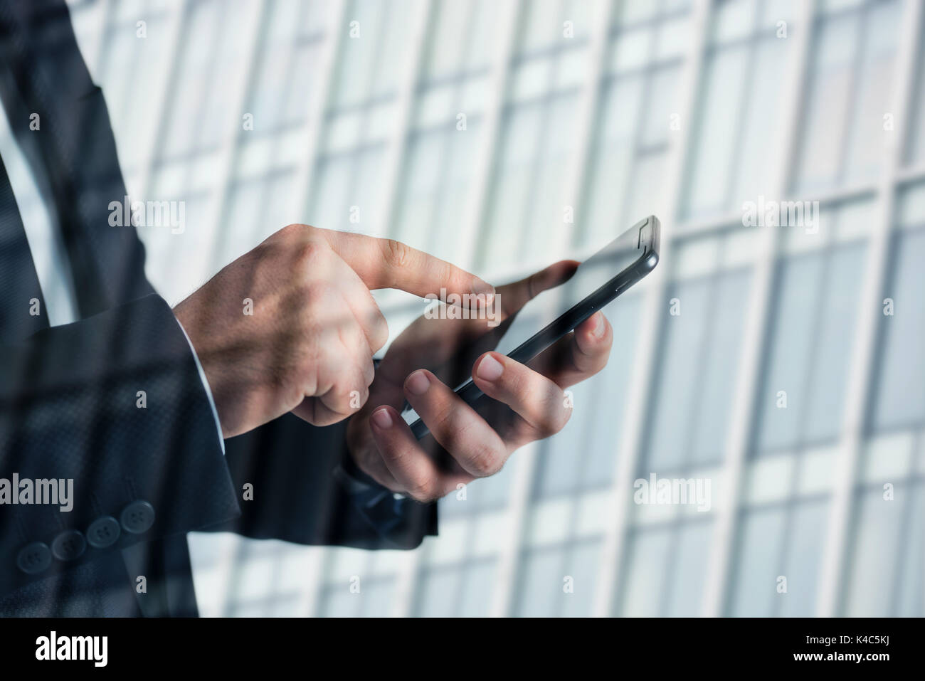 Closeup photo of businessman hands touching screen smartphone. blurred background. Stock Photo