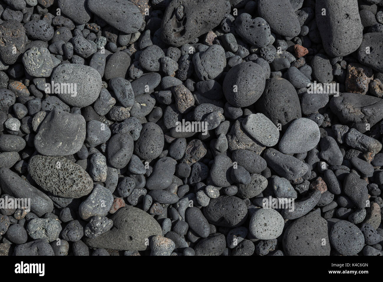 Washed Gray Stones Of Volcanic Origin On The Beach Stock Photo