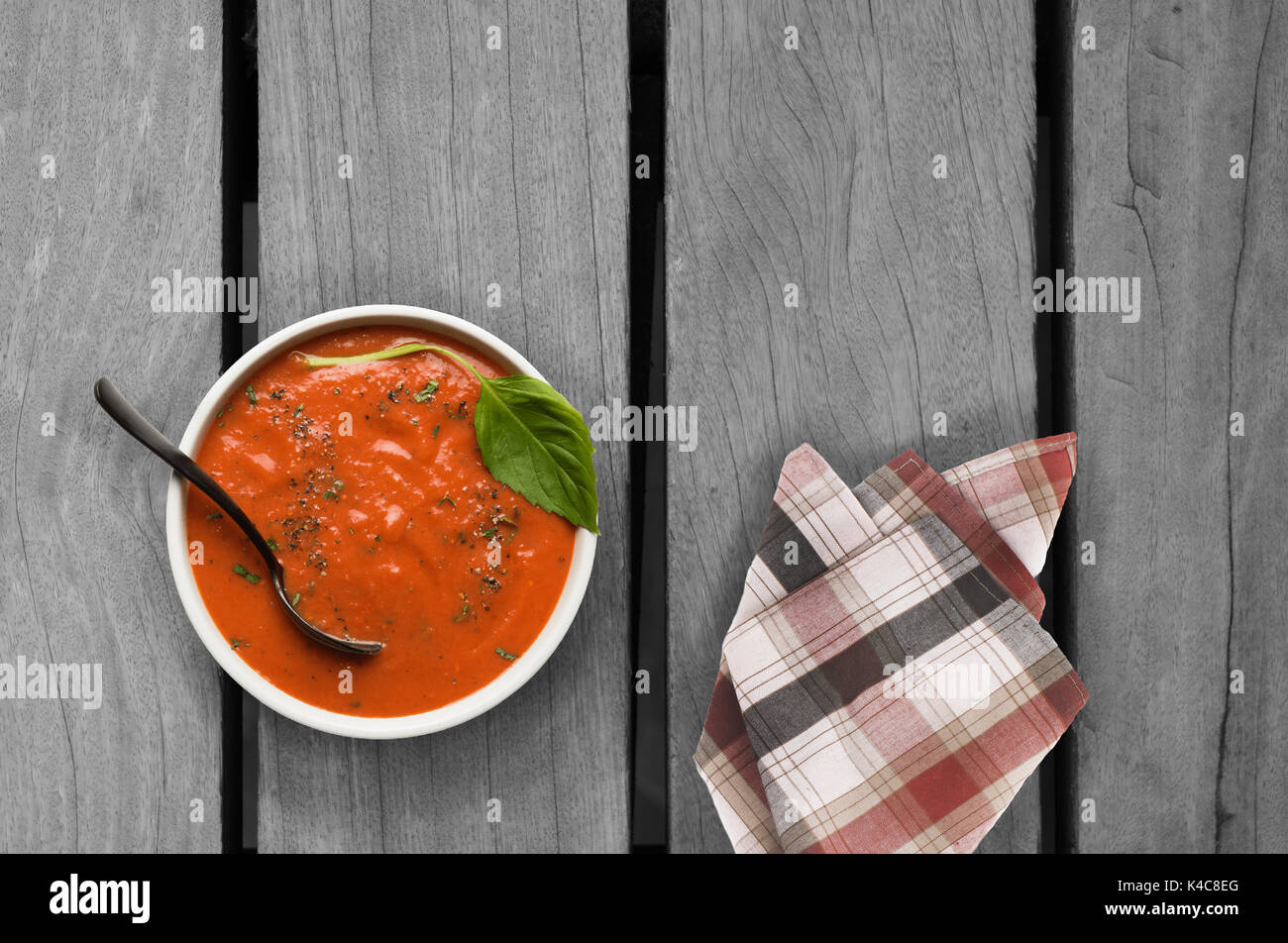 roasted tomato basil soup on wooden table Stock Photo