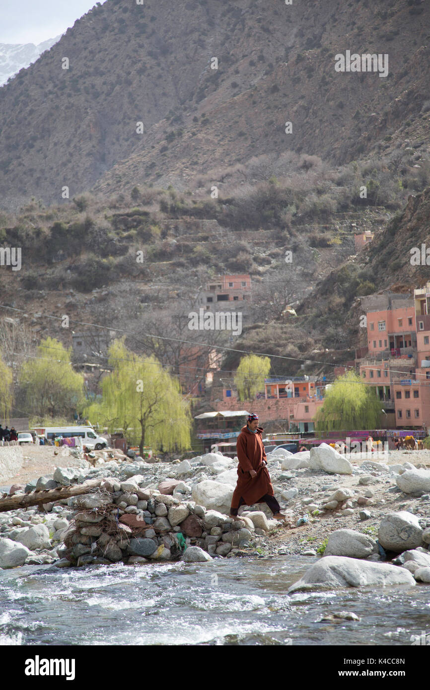 Berber crossing wooden bridge, Setti Fatma market, Ourika valley, Atlas Mountains, Morocco Stock Photo