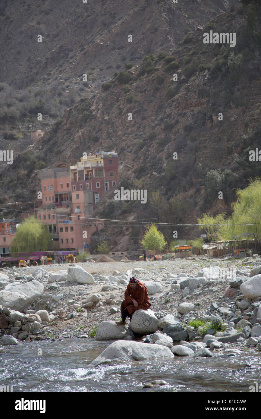 Berber man sitting by river, Setti Fatma, Ourika valley, Atlas Mountains, Morocco Stock Photo
