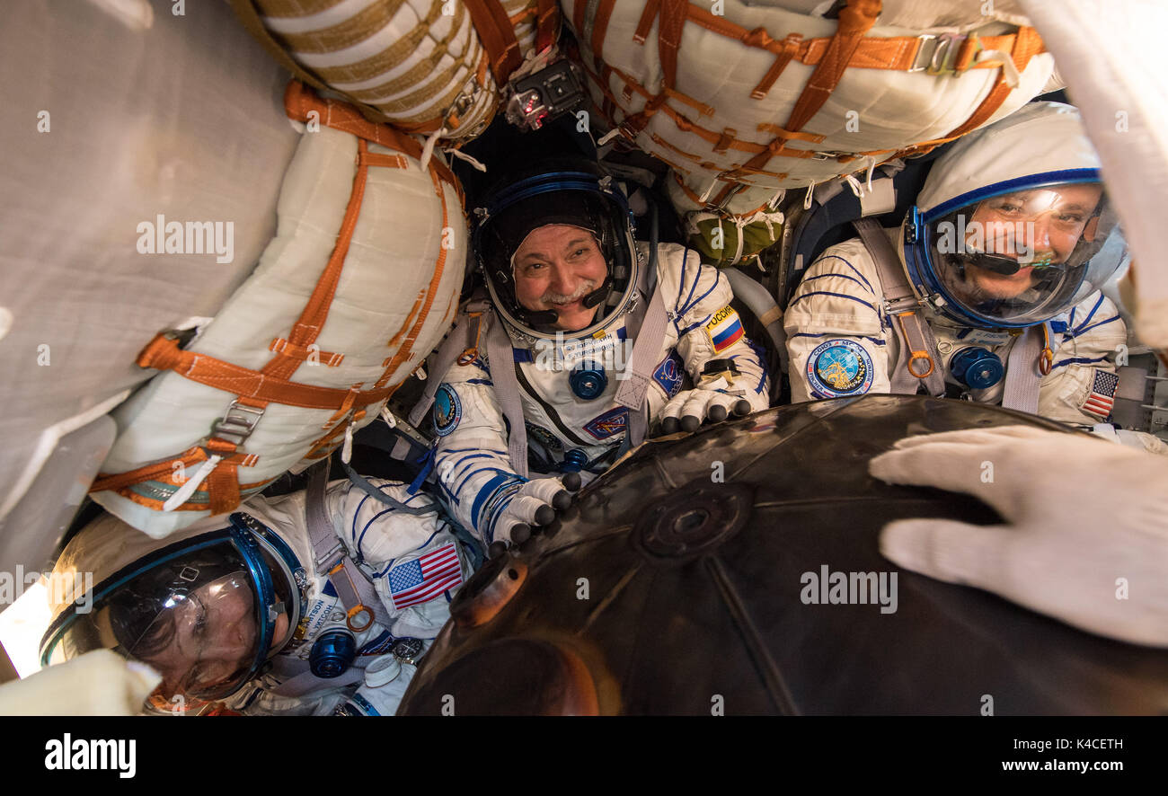 International Space Station Expedition 52 crew Peggy Whitson, left, Commander Fyodor Yurchikhin, center, and   Jack Fischer are seen inside the Soyuz MS-04 spacecraft shortly after landing in a remote area September 3, 2017 near Zhezkazgan, Kazakhstan. Stock Photo