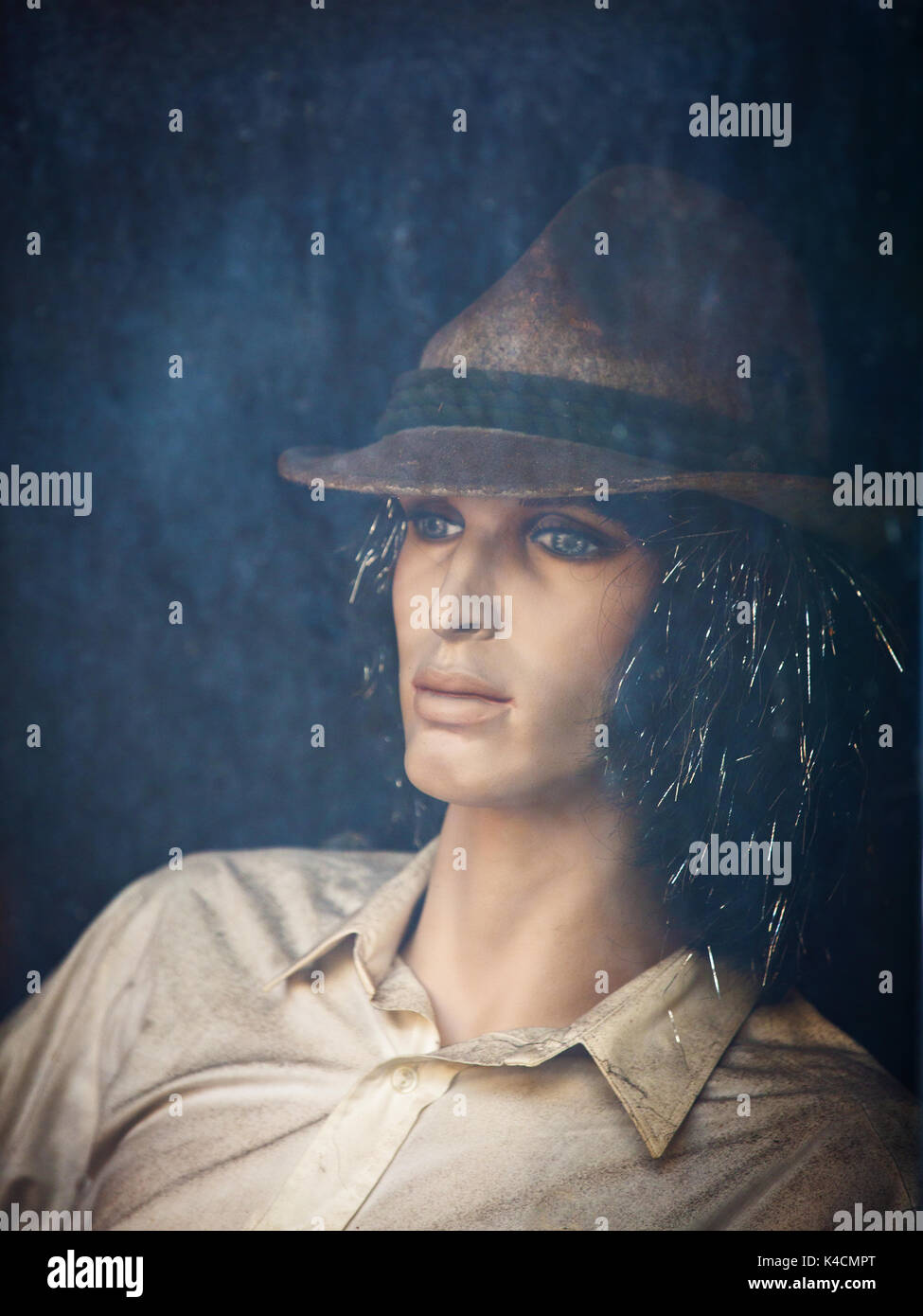 Dirty Male Mannequin Behind Dirty Glass Stock Photo
