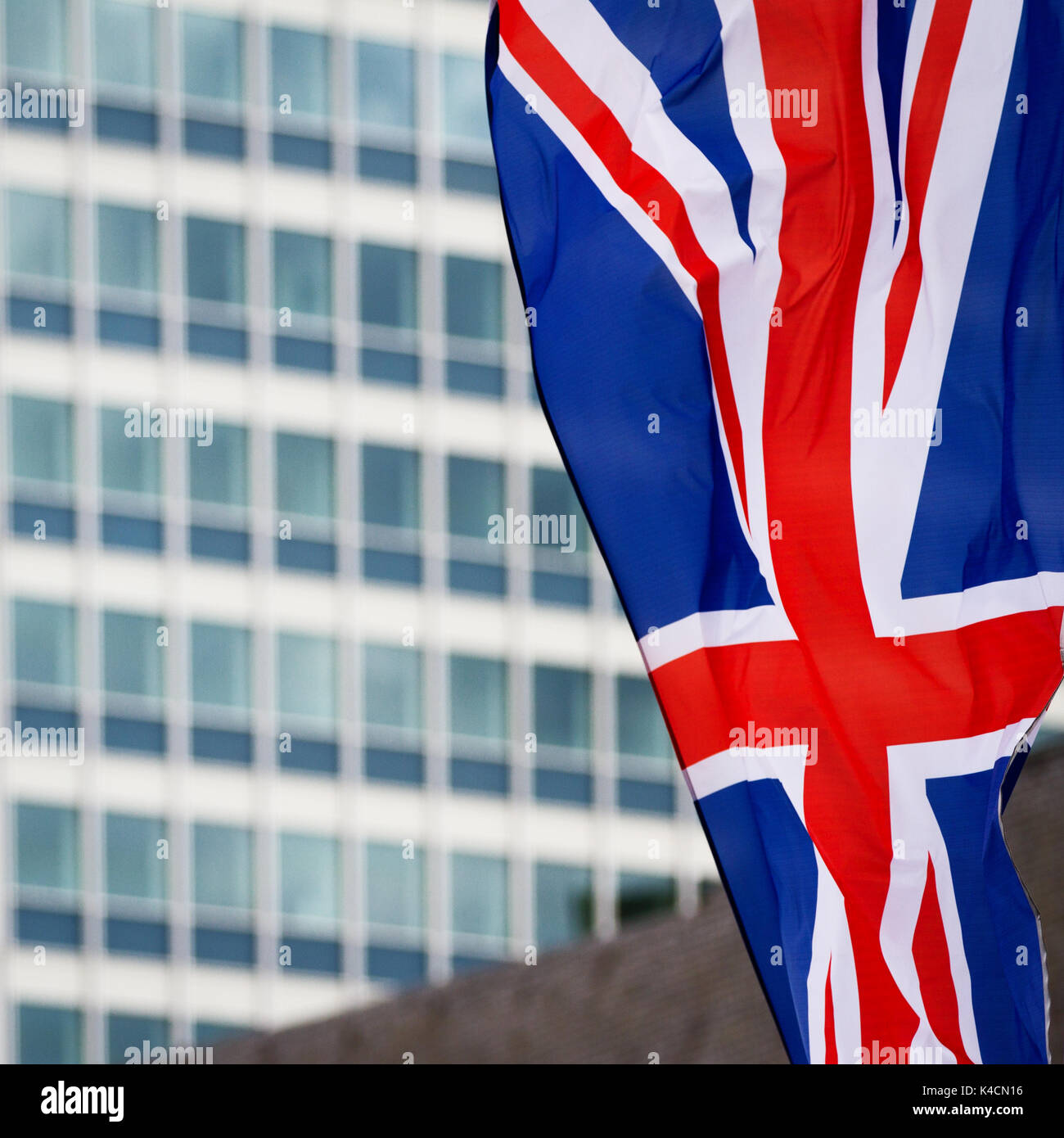 Union Jack In Front Of High-Rise Building Stock Photo