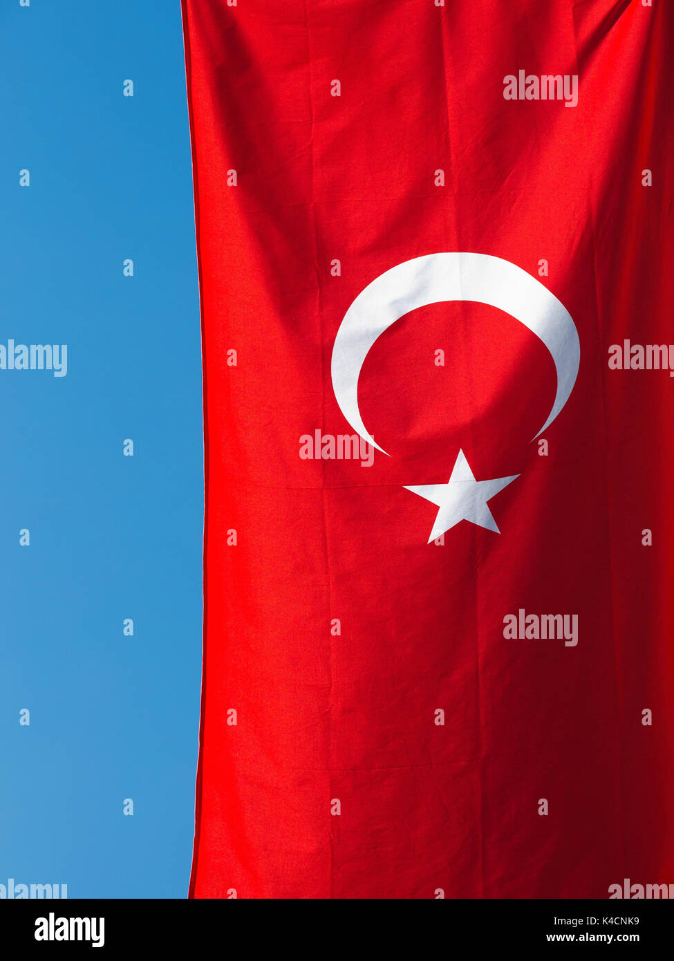 Turkish Flag Against Blue Sky Stock Photo