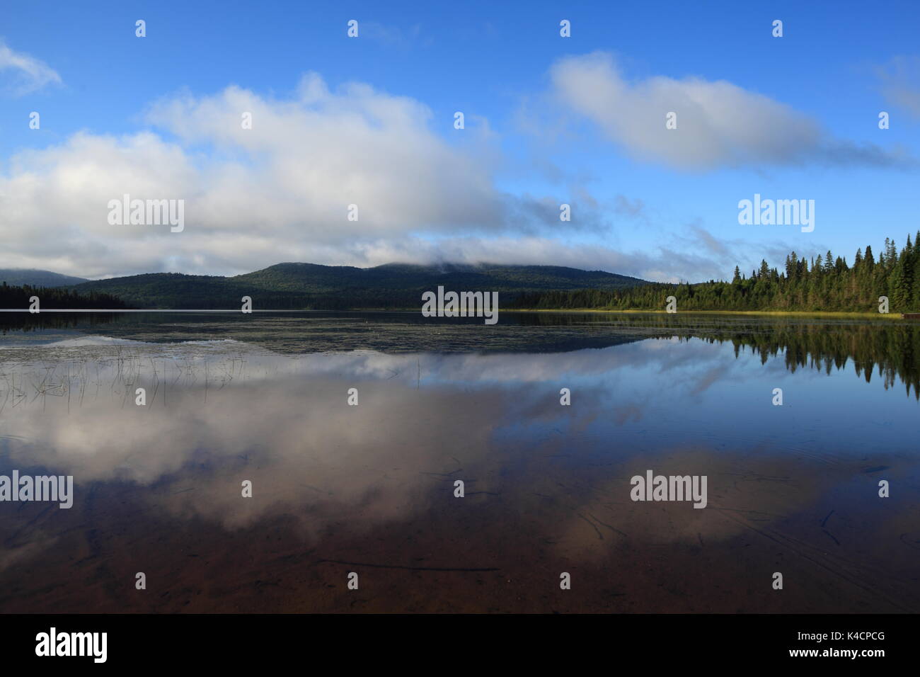 The morning clouds are sitting on the Laurentides Hills at Lac Escalier
