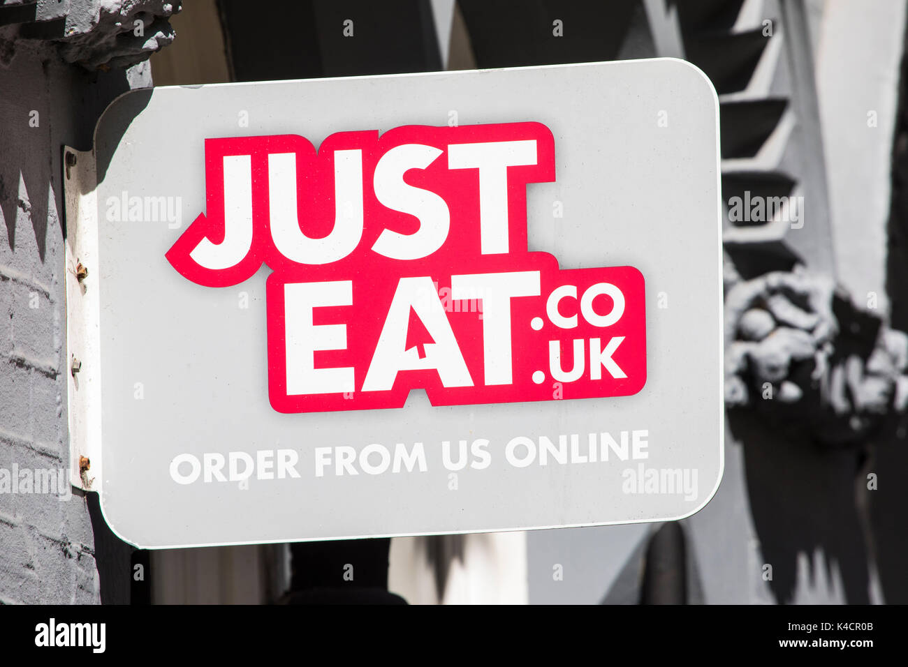 WEYMOUTH, UK - AUGUST 15TH 2017: A Just Eat sign outside a takeaway restaurant in the seaside town of Weymouth in Dorset, on 15th August 2017. Stock Photo