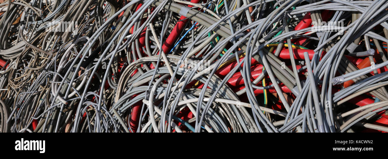 Background of abandoned electrical cables in a dump of recyclable