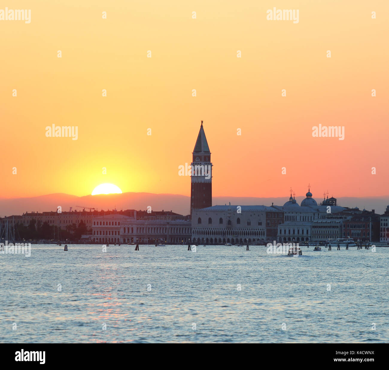 Great Sun at SUNSET in VENICE in Italy and the Campanile of Saint Mark ...