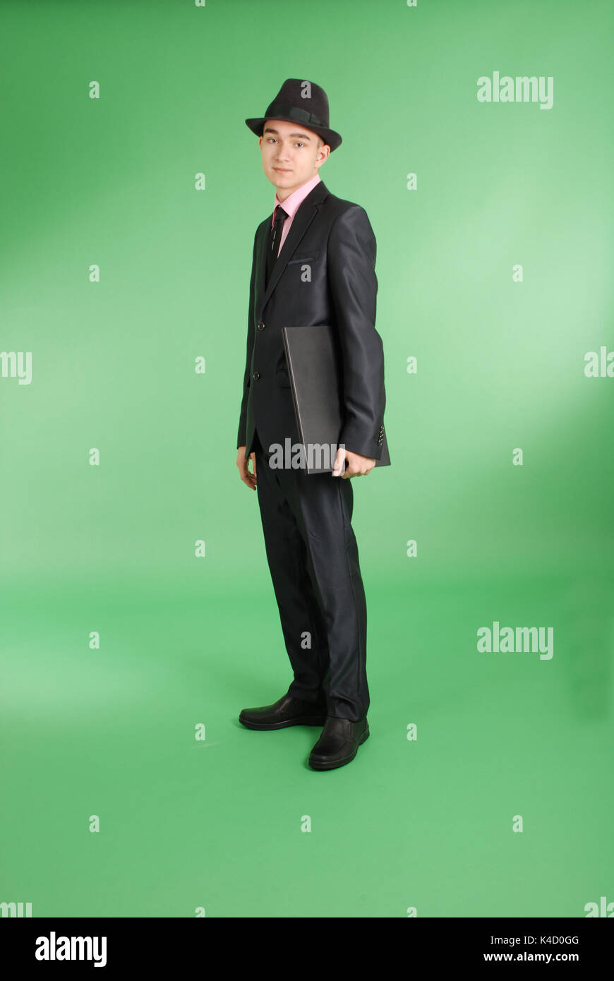 Full length portrait of confident mature businessman with a laptop in ...