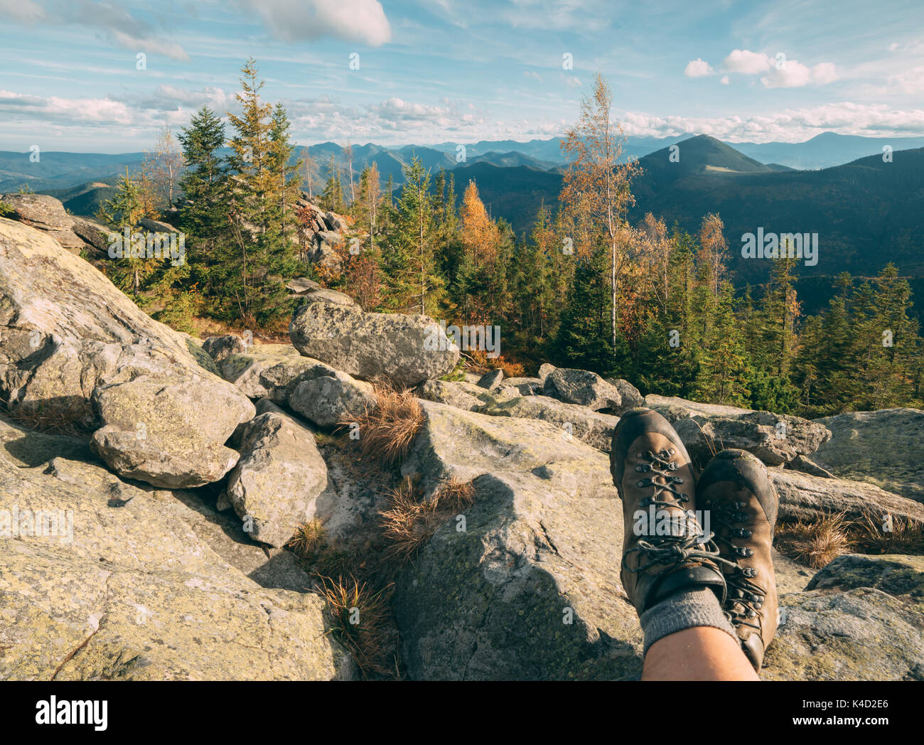 Resting tourist legs in hiking boots Stock Photo