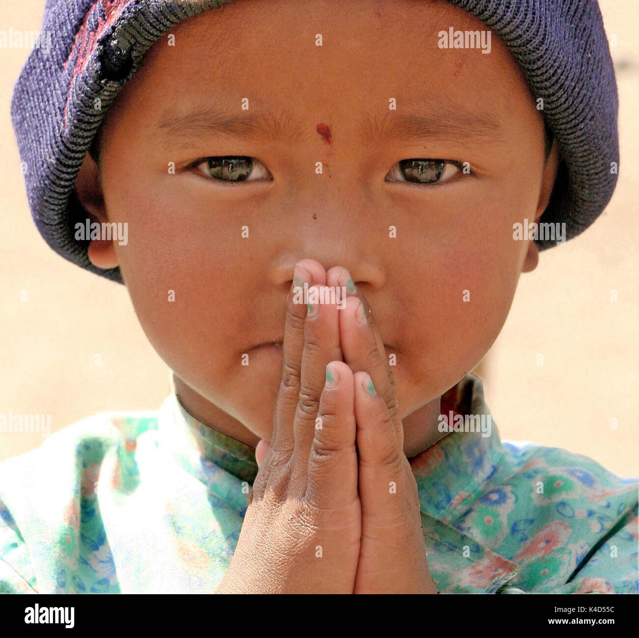 Young girl giving the treditional Nepal greeting of Namaste. Kathmandu