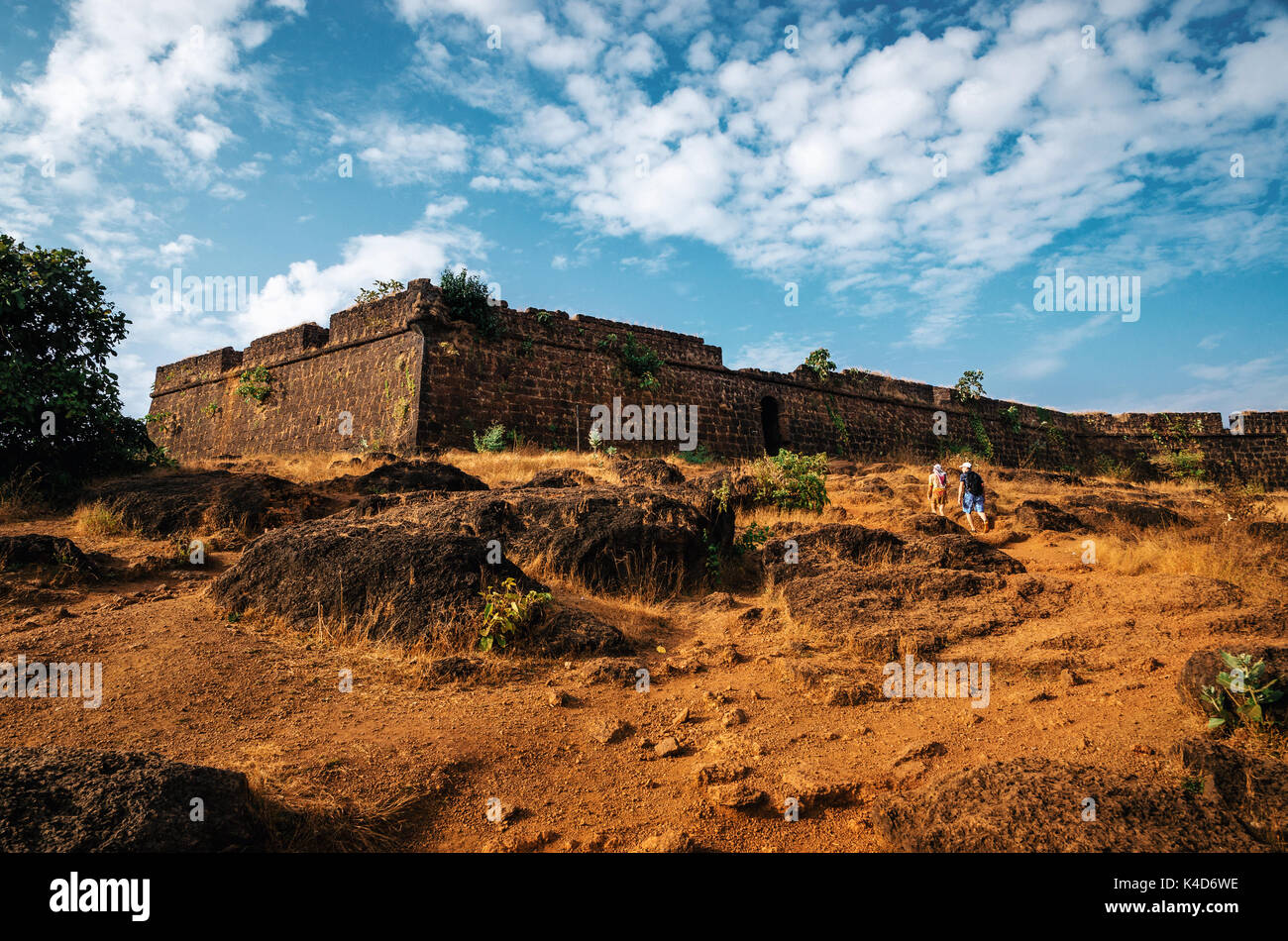 Tourists go to the ruins of Chapora fort, located near Vagator village, North Goa, India Stock Photo