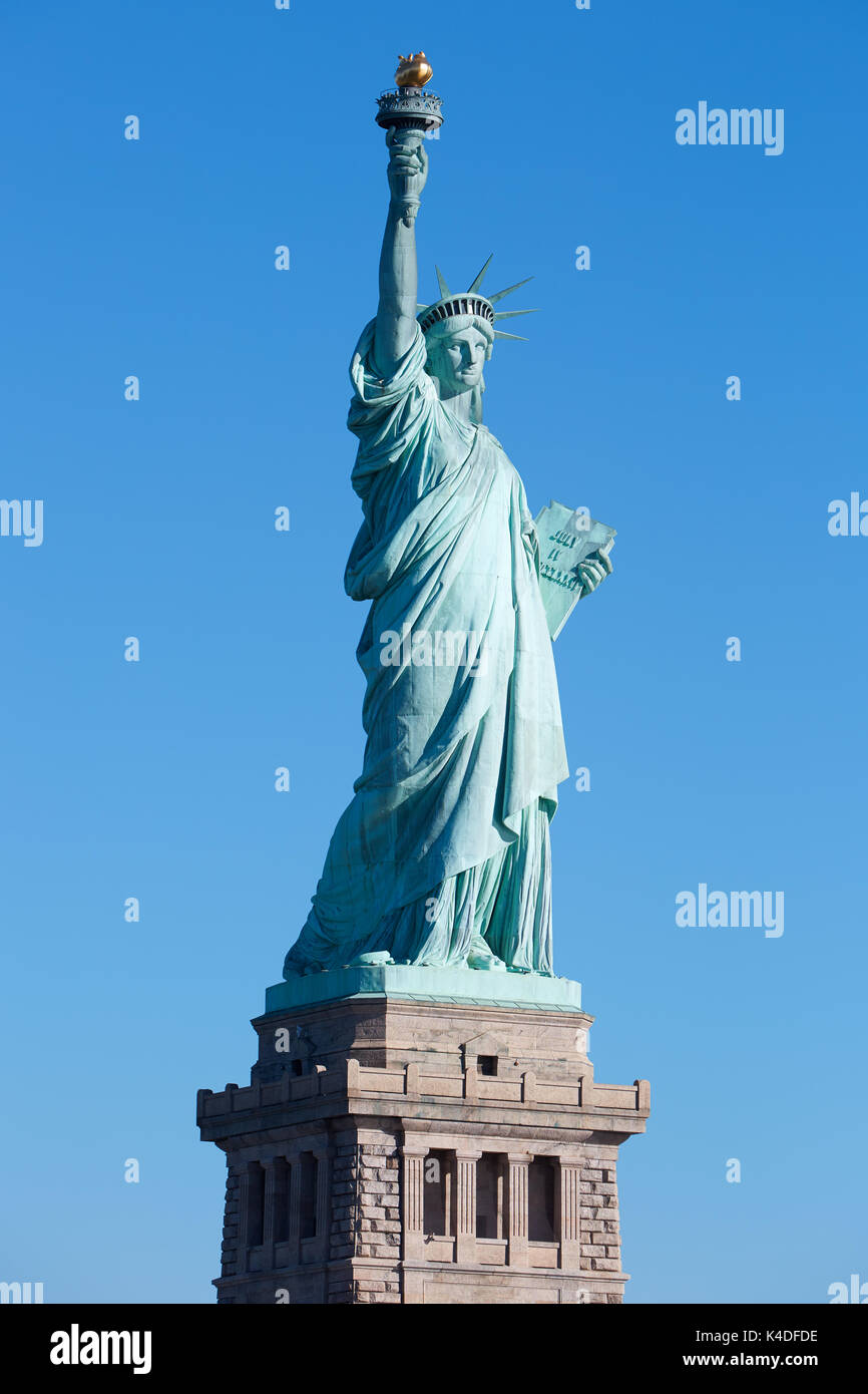 Statue of Liberty with pedestal lateral view in a sunny day, clear blue sky in New York Stock Photo