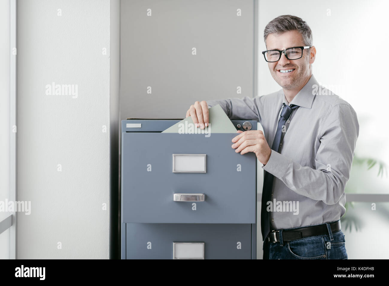 Office worker searching files in hi-res stock photography and images ...
