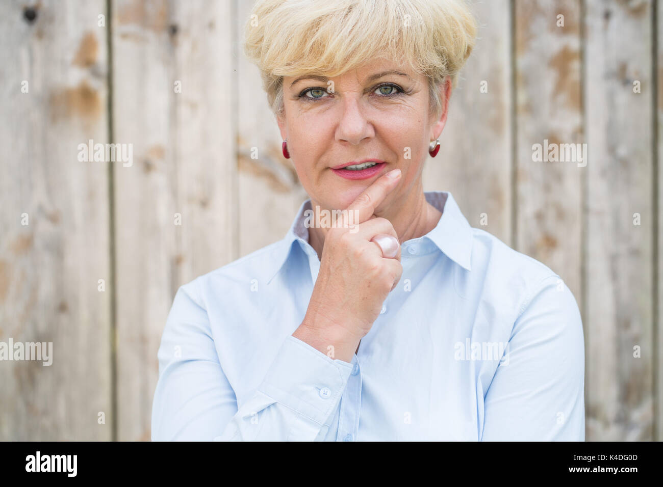 Portrait of an active senior woman looking at camera with a pens Stock Photo