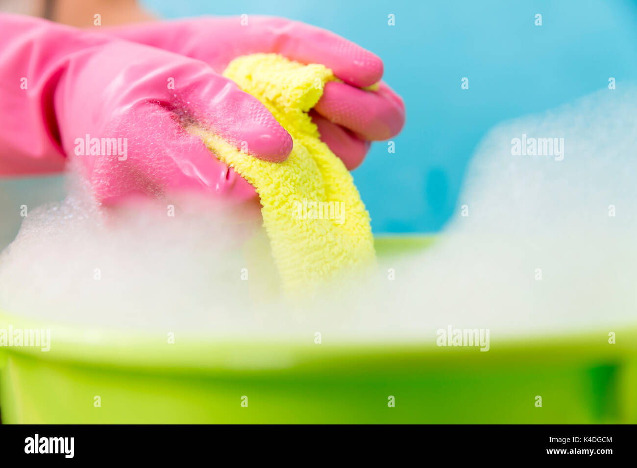 Close Up Of Cleaner Woman Hand Squeezing Cloth In Bucket Filled With