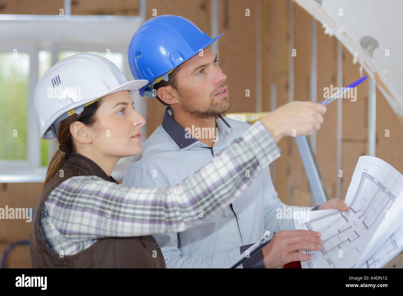 two young architects discuss about construction plan Stock Photo
