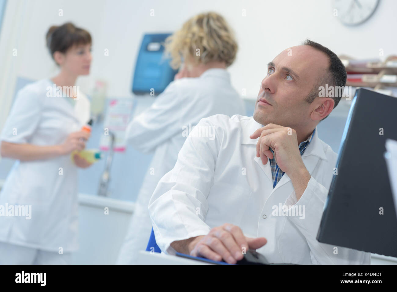 puzzled radiologist looking at mri in computer Stock Photo