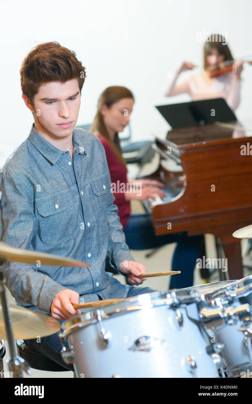young drummer with drumsticks in a music class Stock Photo Alamy
