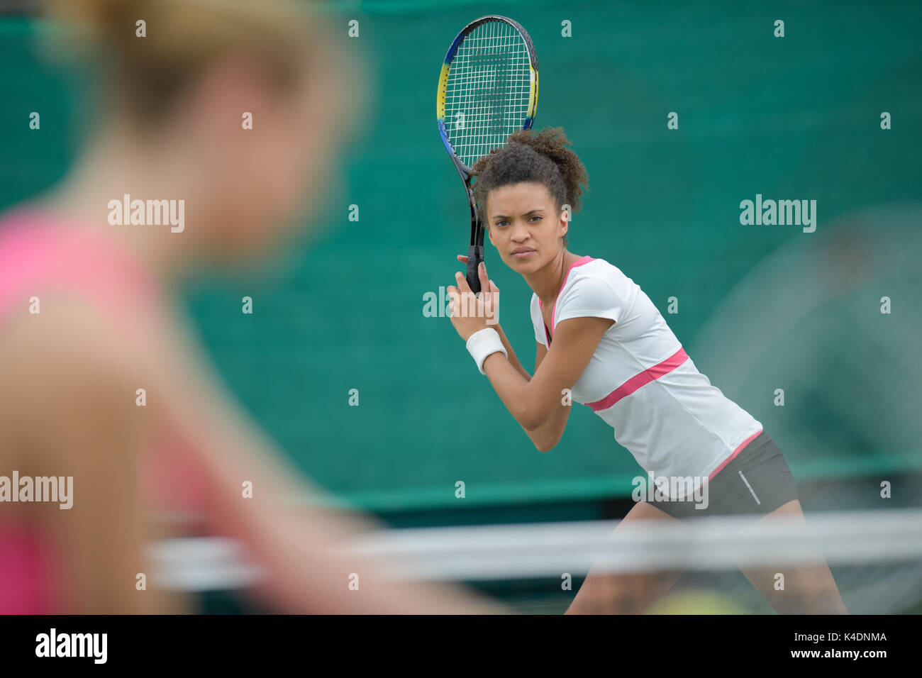 tennis female player ready to serve on clay court outdoor Stock Photo