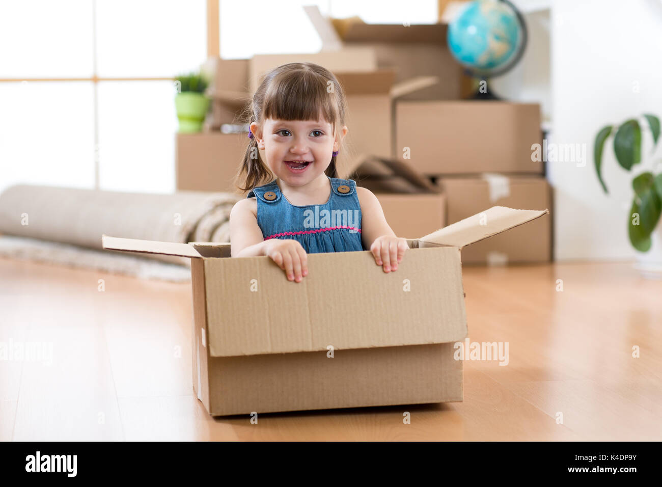 Beautiful girl inside cardboard box hires stock photography and images