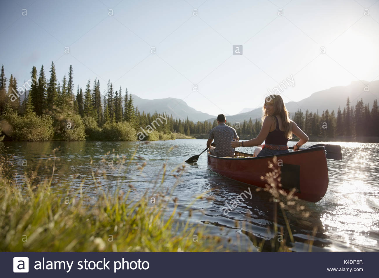 Couple in canoe on sunny summer lake Stock Photo Alamy