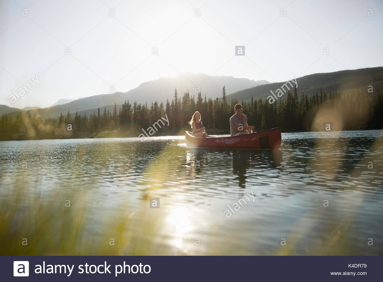 Couple in canoe on sunny summer lake Stock Photo