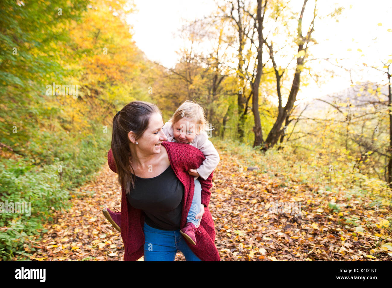 Mother and daughter on a walk in autumn forest Stock Photo - Alamy