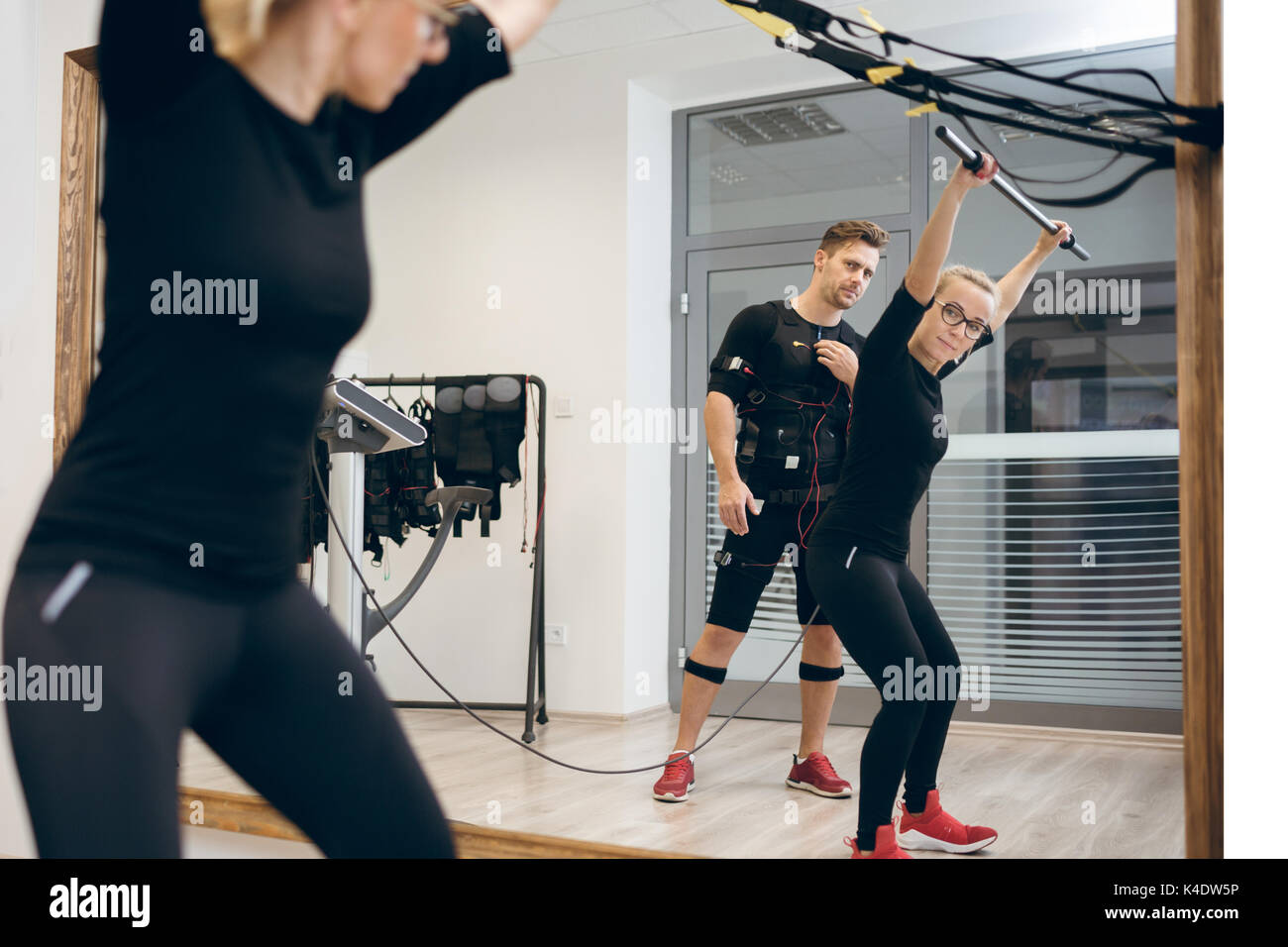 EMS Electro Stimulation Women Exercises with Coach in Modern Gym Stock  Image - Image of fitness, personal: 147937565