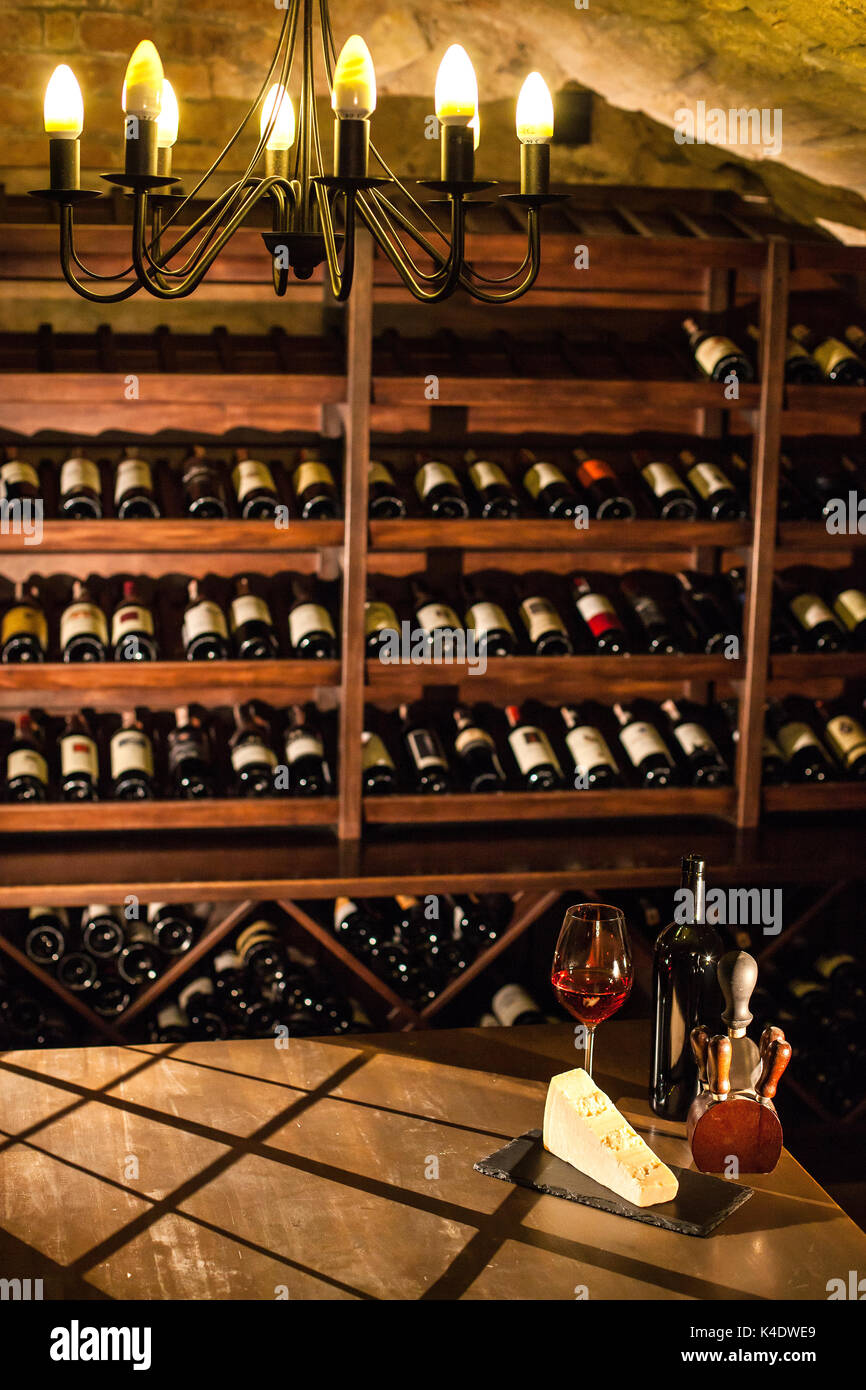 Wine vault. Nice composition of wine glass, cheese and accessories on a