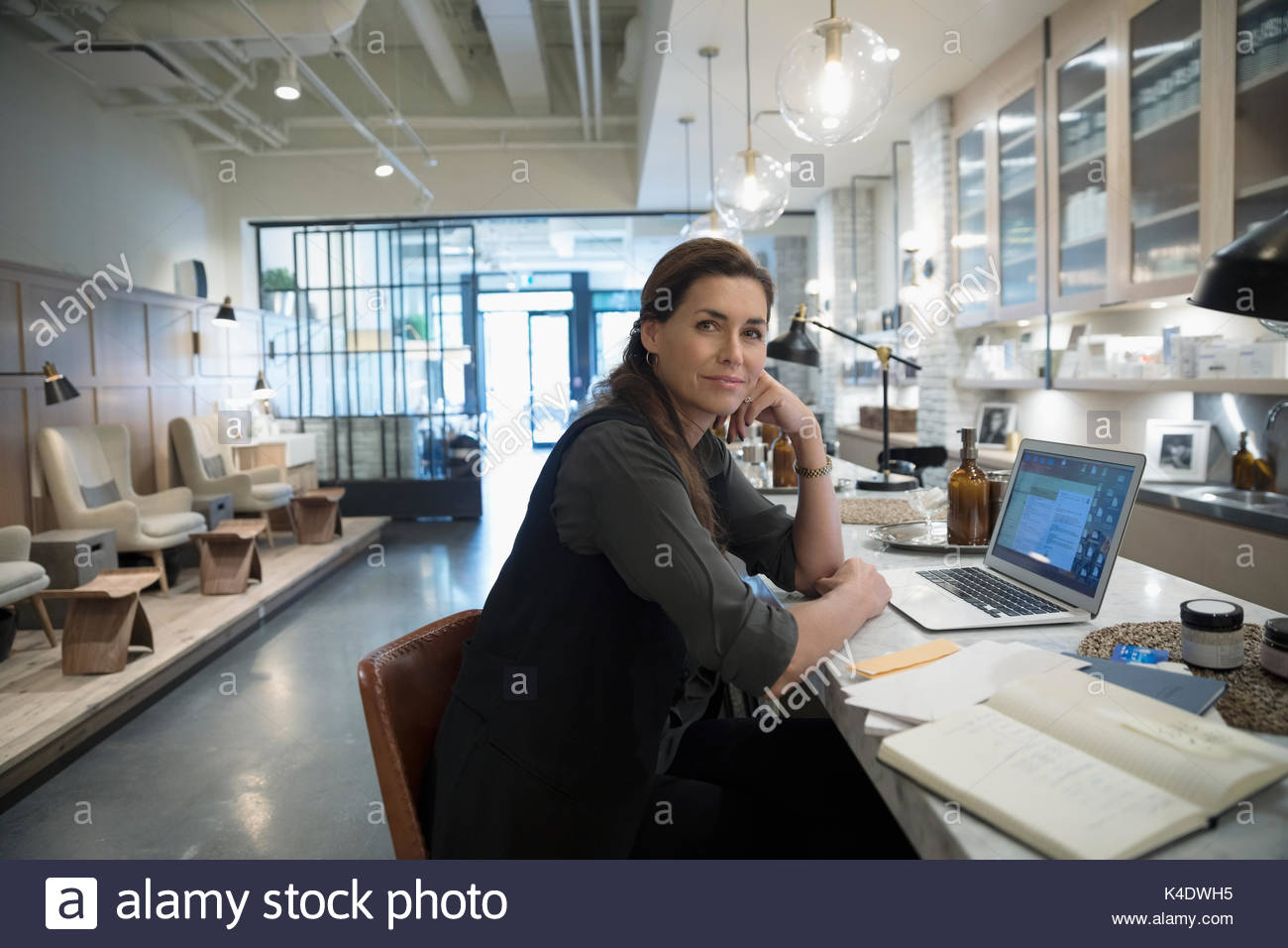Portrait confident female nail salon owner working at laptop Stock Photo Alamy