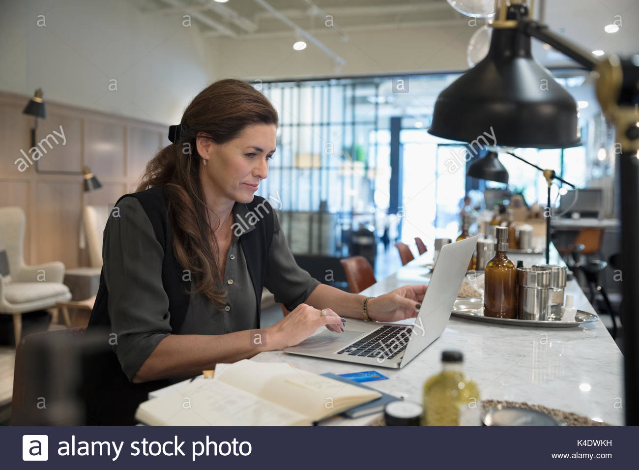 Female nail salon owner working at laptop Stock Photo Alamy