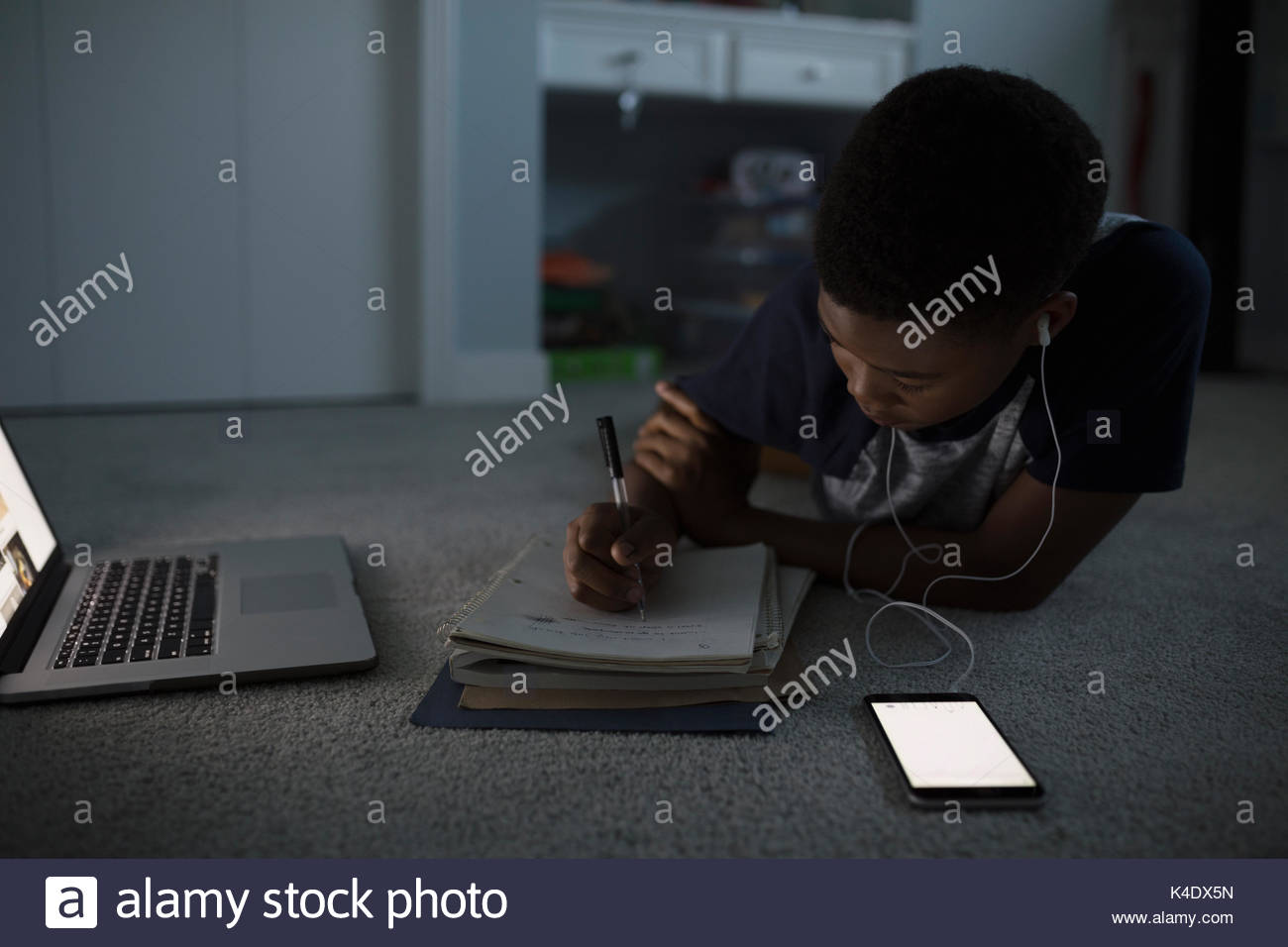 Teenage boy with headphones listening to music with mp3 player and