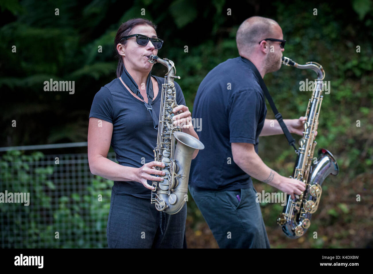 Two musicians performing on their saxophones. Stock Photo